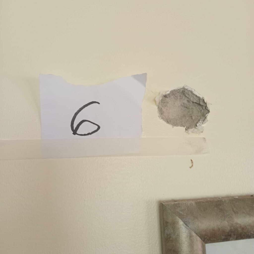 Moalboal: 2 brothers tagged as shooters in strafing attack. This is one of the bullet holes found at the cement wall of the sleeping quarters of security guards of a private lot in Barangay Saavedra, Moalboal town in southern Cebu after they were strafed by two armed brothers on Monday, August 5. | Contributed photo via Paul Lauro