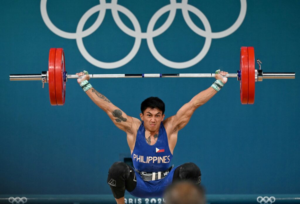 Olympian Ceniza gets boost from mom, coaches, local sports heads. Philippines' John Febuar Ceniza competes in the men's -61kg weightlifting event during the Paris 2024 Olympic Games at the South Paris Arena in Paris, on August 7, 2024. (Photo by Miguel MEDINA / AFP)