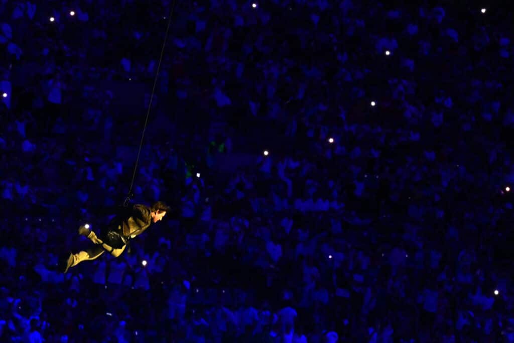 Paris closes out 2024 Olympics with final star-studded show. US' actor Tom Cruise lands from the roof in front one of the stadium entrances during the closing ceremony of the Paris 2024 Olympic Games at the Stade de France, in Saint-Denis, in the outskirts of Paris, on August 11, 2024. (Photo by Miguel MEDINA / AFP)