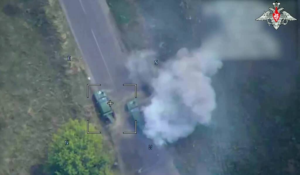 An image taken from a handout footage released by the Russian Defence Ministry on August 12, 2024, shows a Russian drone attack on Ukrainian armoured vehicles in Kursk Region. | Photo by Russian Defence Ministry / AFP