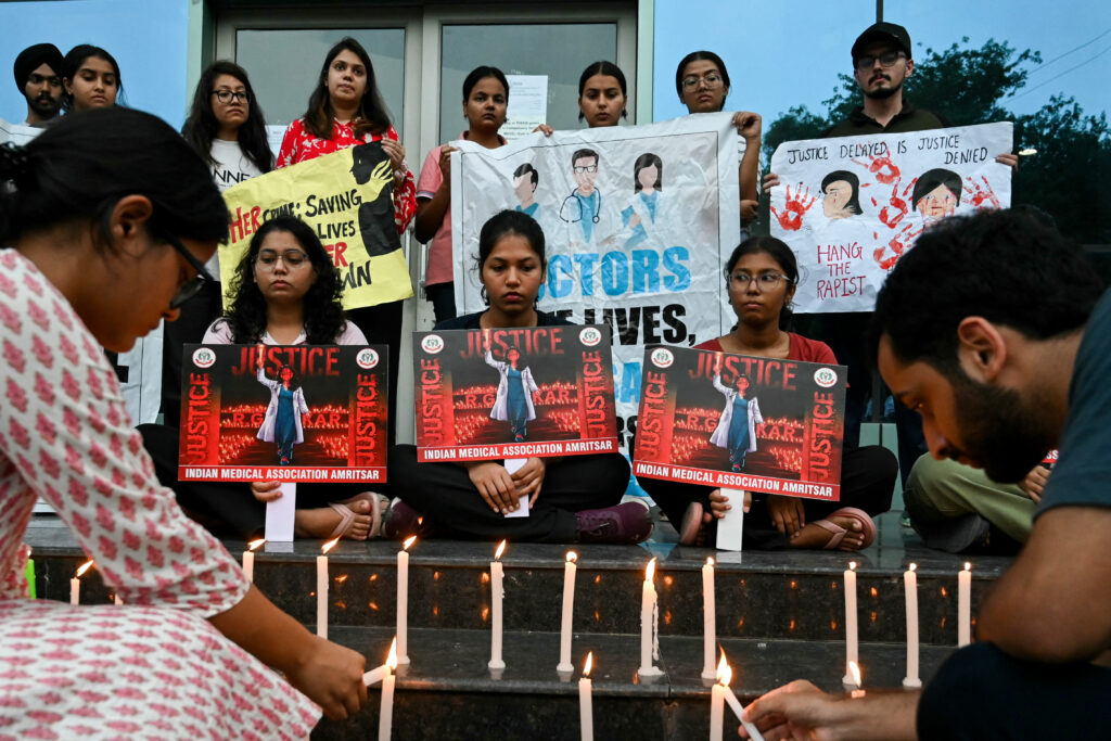 Indian doctor's rape, murder sparks protests, unite soccer fans. Medical professionals light candles as they pay tribute to a victim of the rape and murder of a young medic from Kolkata, in Amritsar on August 18, 2024. | Photo by Narinder NANU / AFP