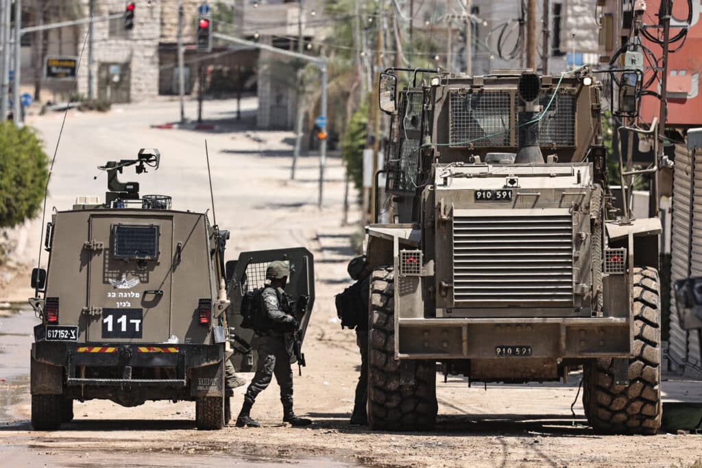 Ceasefire hopes fade as Gaza fighting rages. In photo are Israeli soldiers and military vehicles being deploy in the occupied West Bank refugee camp of Tulkarm on August 22, 2024. | Photo by Zain JAAFAR / AFP