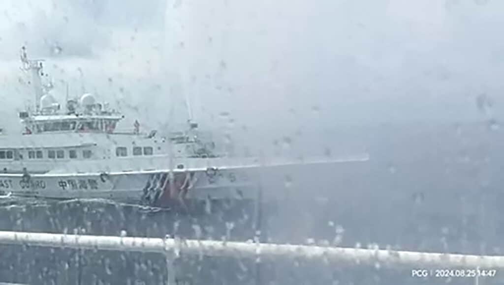 This frame grab from handout video footage taken and released on August 25, 2024 by the Philippine Coast Guard (PCG) shows a Chinese coast Guard ship (L) using water cannon against the Philippine Bureau of Fisheries and Aquatic Resources (BFAR) vessel BRP Datu Sanday, near Sabina Shoal in disputed waters of the South China Sea. | Photo by Handout / Philippine Coast Guard (PCG) / AFP