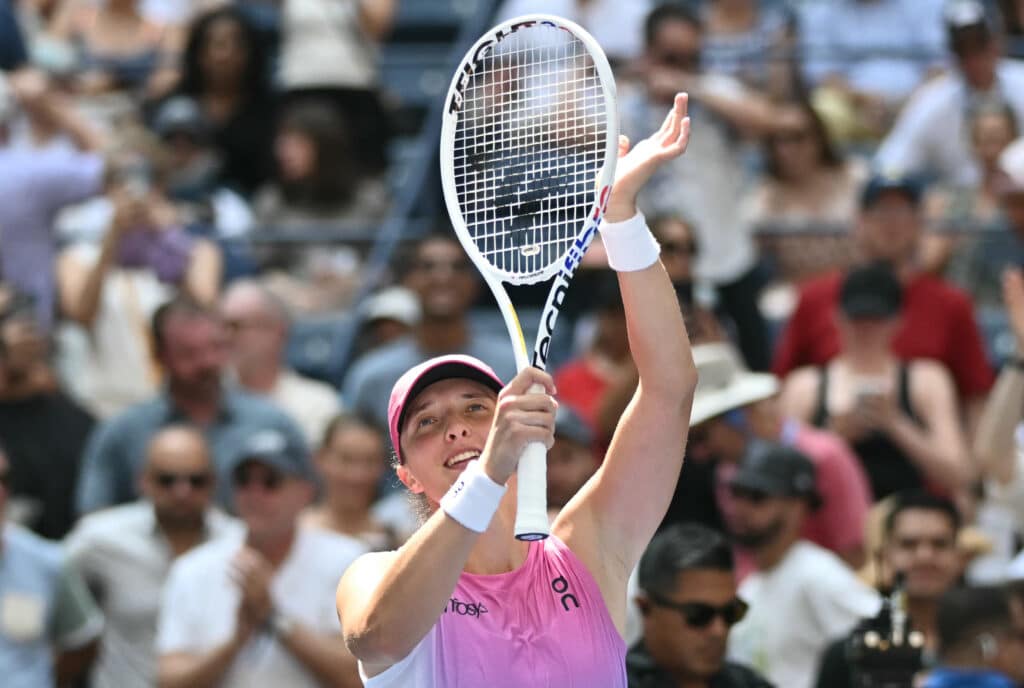 Poland's Iga Swiatek celebrates defeating Russia's Kamilla Rakhimova in their women's singles first round match on day two of the US Open tennis tournament at the USTA Billie Jean King National Tennis Center in New York City, on August 27, 2024. | Photo by ANGELA WEISS / AFP