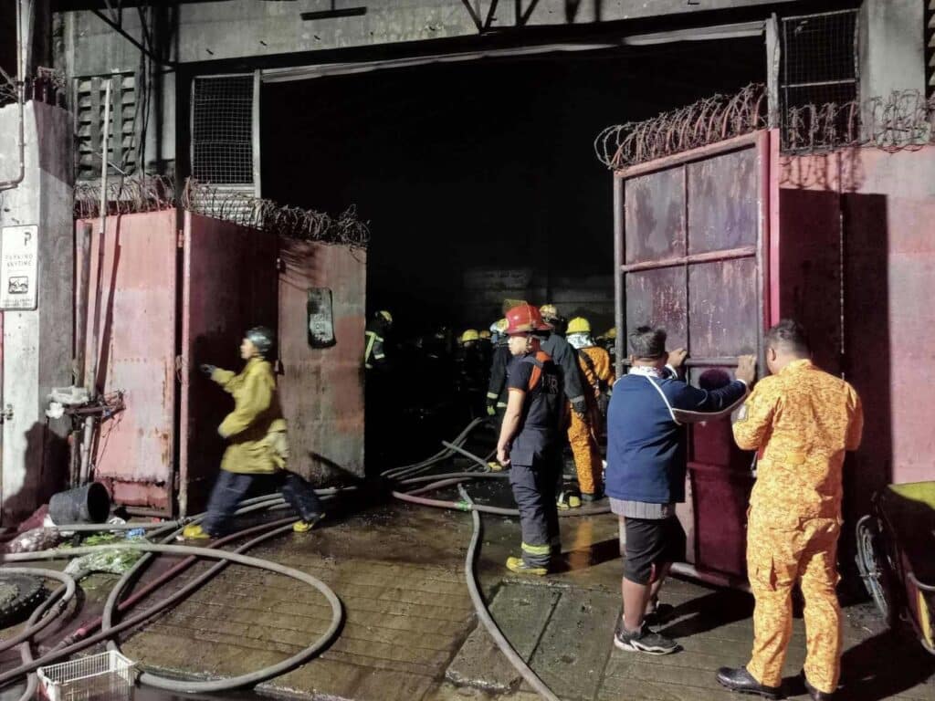 Cebu City warehouse fire: P6M worth of properties destroyed: In photo are firefighters doing overhauling at the fire-damaged warehouse.