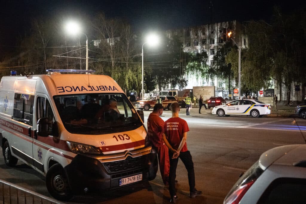 Medical workers wait outside of a military educational facility after it was hit by Russian missiles in Poltava, eastern Ukraine on September 3, 2024, amid the Russian invasion of Ukraine. Photo by Patryk Jaraccz / AFP