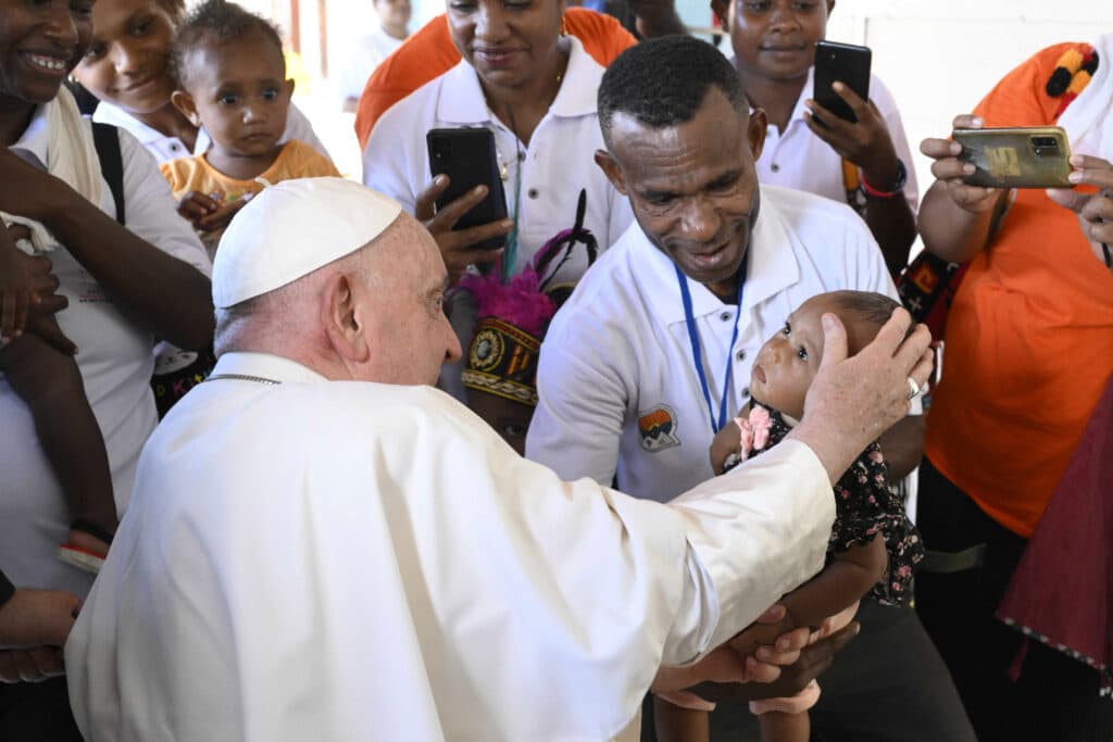 Pope talks about his travails: ‘This job is not easy’. Photo is handout picture taken and released on September 8, 2024 by the Vatican Press Office shows Pope Francis blessing a child at the Holy Trinity Humanities School in Baro, Papua New Guinea. Photo by Handout / VATICAN MEDIA / AFP