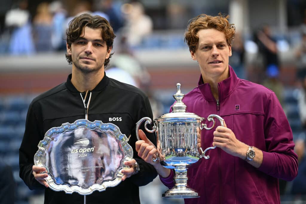 In photo are Italy's Jannik Sinner and USA's Taylor Fritz holding their trophies after their men's final match on day fourteen of the US Open tennis tournament at the USTA Billie Jean King National Tennis Center in New York City, on September 8, 2024. | Photo by ANGELA WEISS / AFP