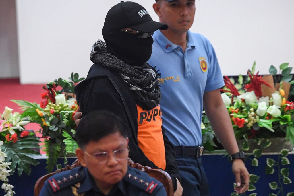 Quiboloy timeline: From Senate probe to cases filed to his arrest. In photo is Apollo Quiboloy (C, in orange), pastor and founder of the Philippine-based Kingdom of Jesus Christ (KOJC) church, who is presented to the media while Philippine National Police chief Rommel Marbil (front) looks on during a press conference at the national police headquarters in Manila on September 9, 2024.(Photo by Ted ALJIBE / AFP)