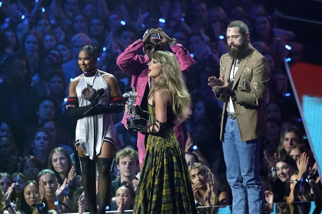 US singer-songwriter Taylor Swift (C) and US rapper Post Malone (R) accept the Best Collaboration award for "Fortnight" on stage during the MTV Video Music Awards at UBS Arena in Elmont, New York, on September 11, 2024. (Photo by TIMOTHY A. CLARY / AFP)