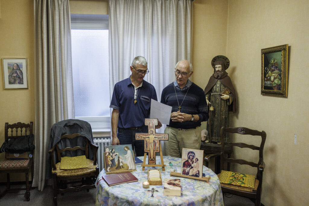 Belgian exorcist offers 'healing' — and combats cliches. Thierry Moser, priest of the "Trois Vignes" parish (L) and deacon, Jacques Beckand speak in a room used by priests to conduct exorcism sessions at the Home Saint Joseph in Brussels, on September 11, 2024. | Photo by Simon Wohlfahrt / AFP