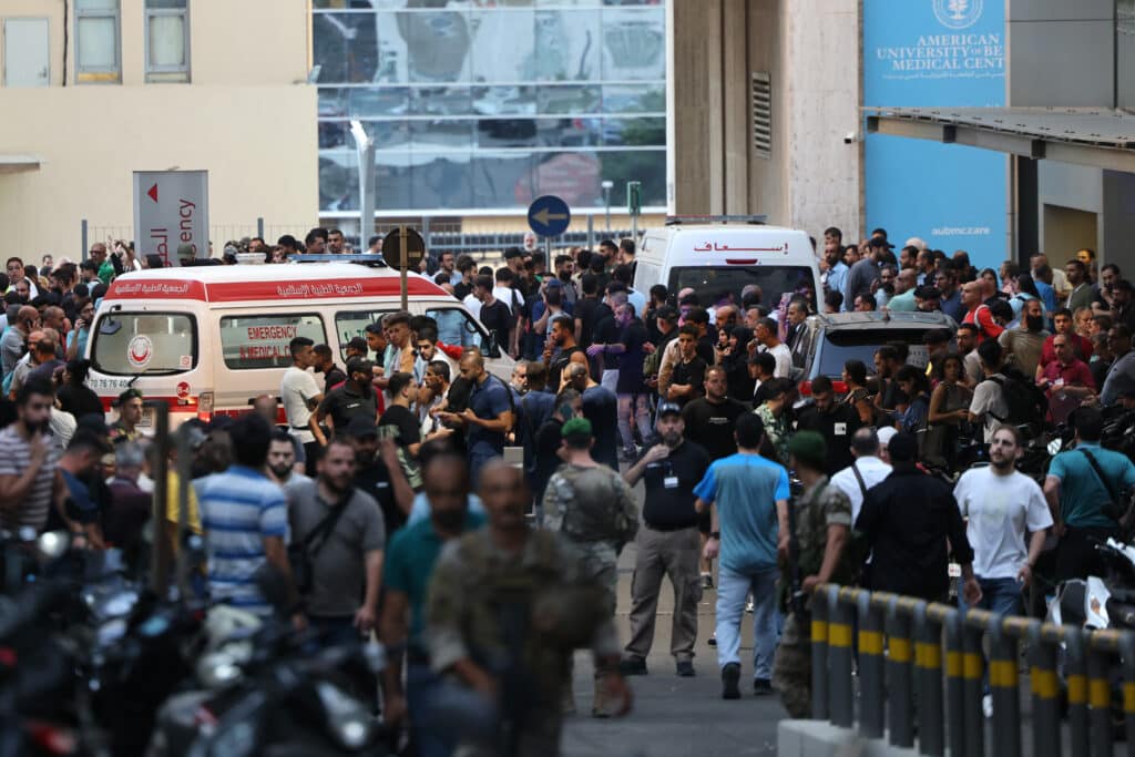 Deadly pager blasts targeting Hezbollah: What to know about them. Ambulances are surrounded by people at the entrance of the American University of Beirut Medical Center, on September 17, 2024, after explosions hit locations in several Hezbollah strongholds around Lebanon amid ongoing cross-border tensions between Israel and Hezbollah fighters. | Photo by ANWAR AMRO / AFP