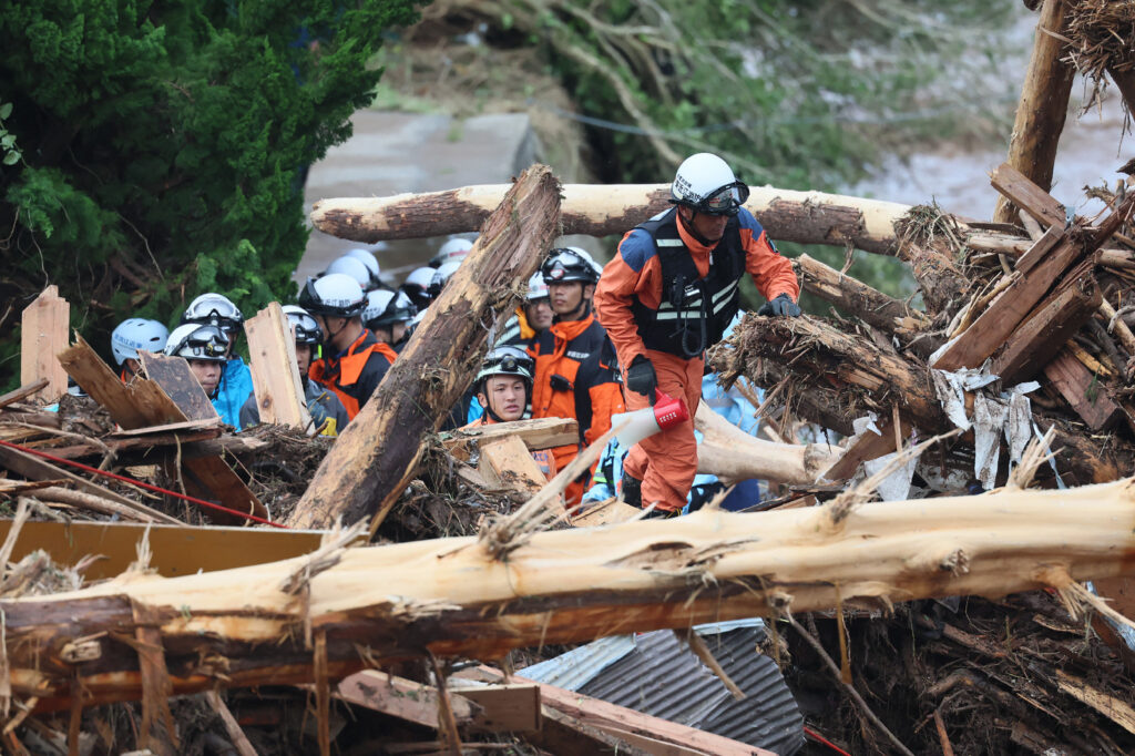 Firefighters search for missing people, through debris washed up after heavy rains caused flooding, in the city of Wajima, Ishikawa prefecture, on September 22, 2024.|Photo by JIJI Press / AFP) / Japan OUT / JAPAN OUT