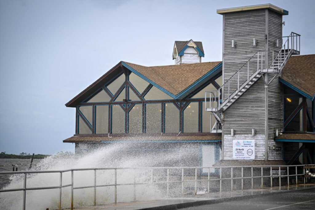 Florida bracing for 'unsurvivable' Hurricane Helene. Waves crash against a building ahead of the arrival of Hurricane Helene in Cedar Key, Florida, on September 26, 2024.| Photo by Miguel J. Rodriguez Carrillo / AFP