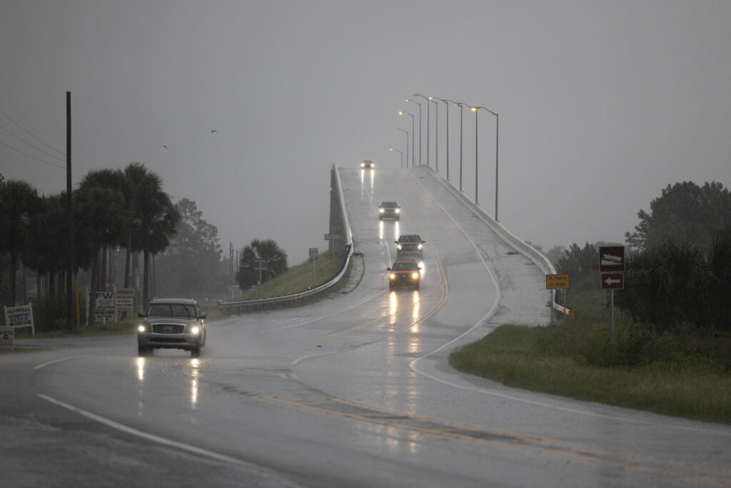 Cars drive over the George G. Tapper Bridge ahead of the arrival of Hurricane Helene in Port Saint Joe, Florida, on September 26, 2024. | Photo by Ricardo ARDUENGO / AFP