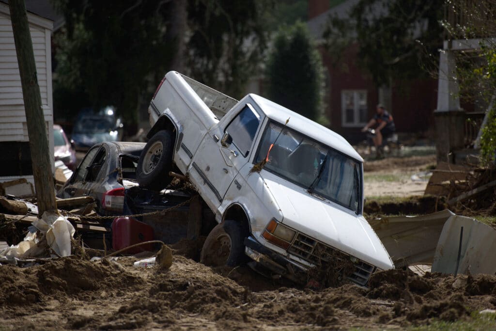 Two vehicles lie upended from flooding in the aftermath of Hurricane Helene on September 29, 2024 in Old Fort, North Carolina.|  Melissa Sue Gerrits/Getty Images/AFP