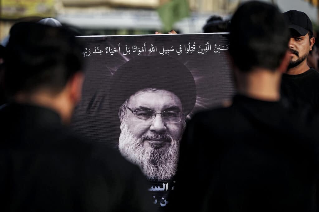 Israel and Hezbollah: Decades of conflict. In photo is a picture of Hassan Nasrallah, the late leader of the Lebanese Shiite group Hezbollah, who was killed in an Israeli air strike in Beirut days earlier, is displayed during a memorial service in Baghdad's eastern suburb of Sadr City on September 29, 2024. This was after Iraq officially declared a three-day national mourning period for Nasrallah. | Photo by AHMAD AL-RUBAYE / AFP