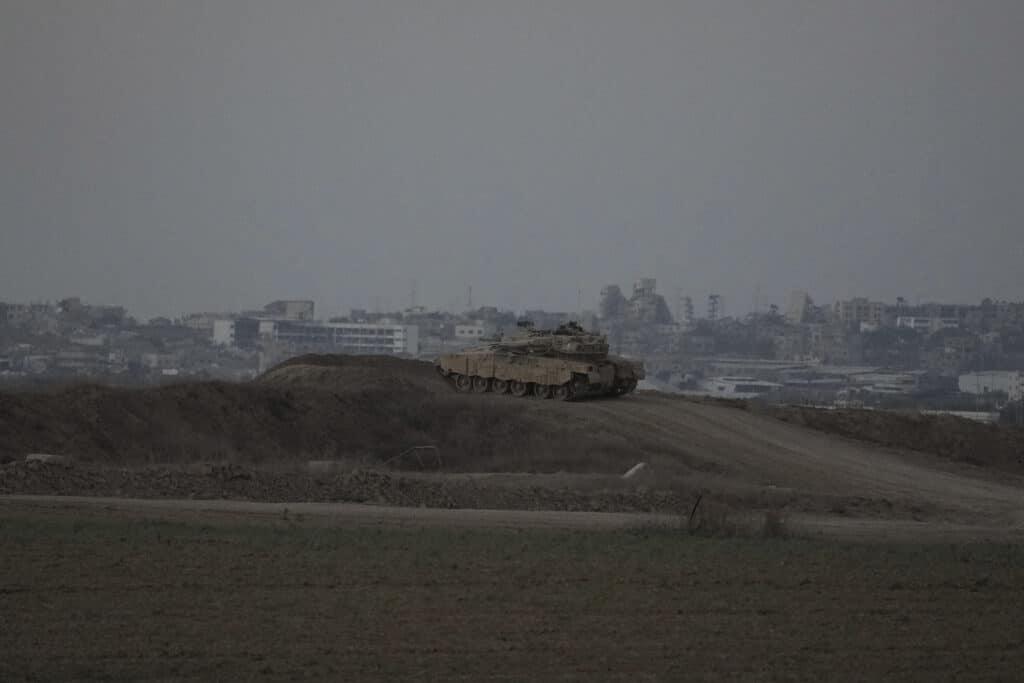 Israel airstrikes in Gaza hit UN school, homes, kill 34 people. In photo is an Israel tank overlooking Gaza Strip.