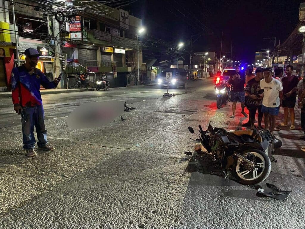 Cebu accident: Motorcycle driver dead, backrider injured. In photo curious onlookers (right) are checking out the motorcycle involved in the crash with a Bongo truck in Minglanilla town in southern Cebu. | Paul Lauro