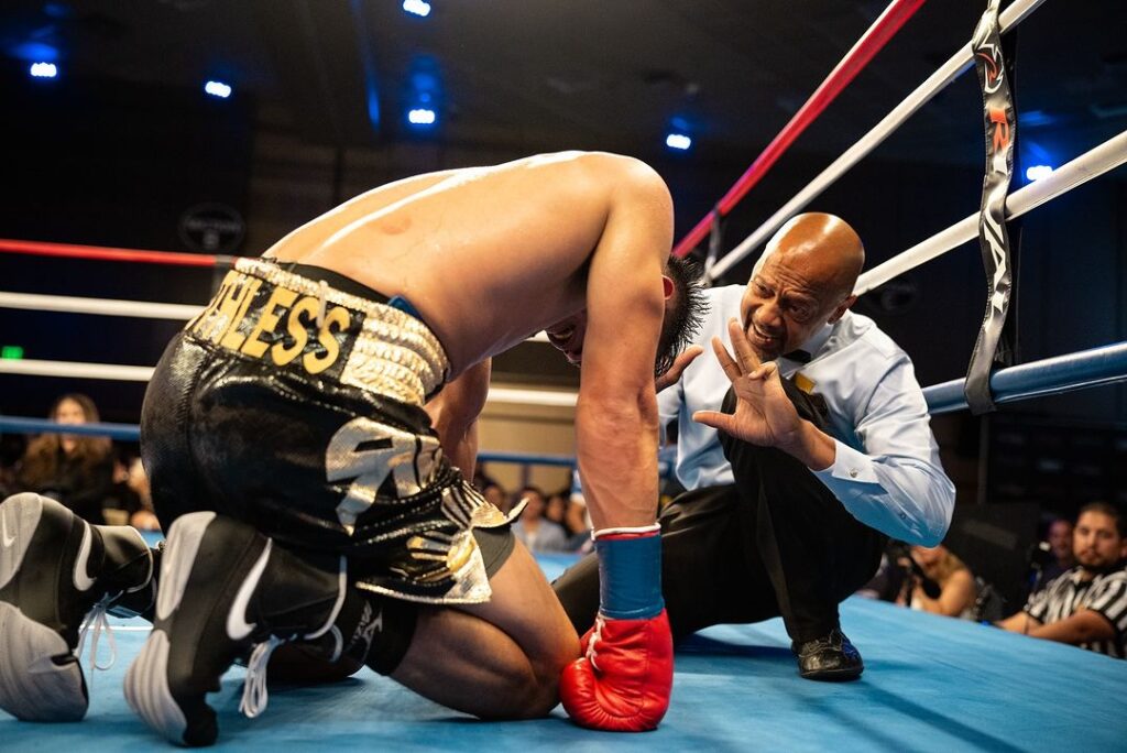 Romero Duno down on his knees while being counted by the referee during his fight in the United States against Cain Sandoval. | Photo from Sandoval's Instagram account.