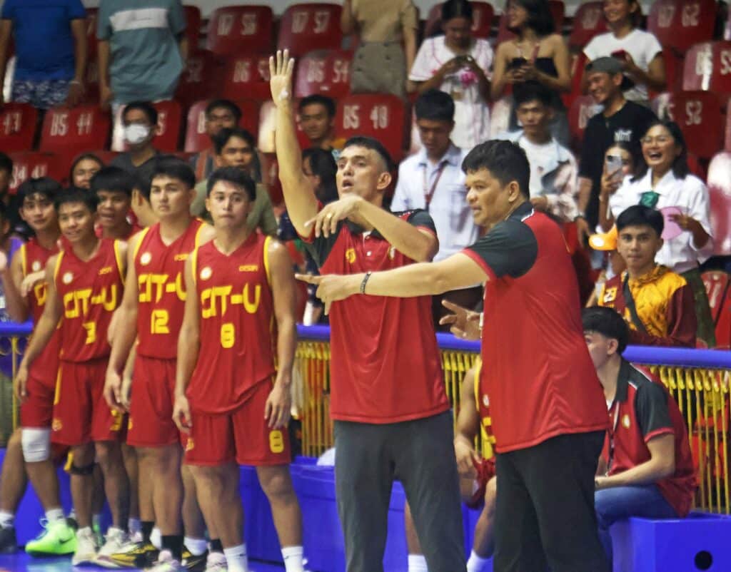 Gerry Cavan (second from right) with assistant coach Rey Dela Victoria (rightmost) calling shots during their Cesafi game against the USPF Panthers. | Photo from Sugbuanong Kodaker