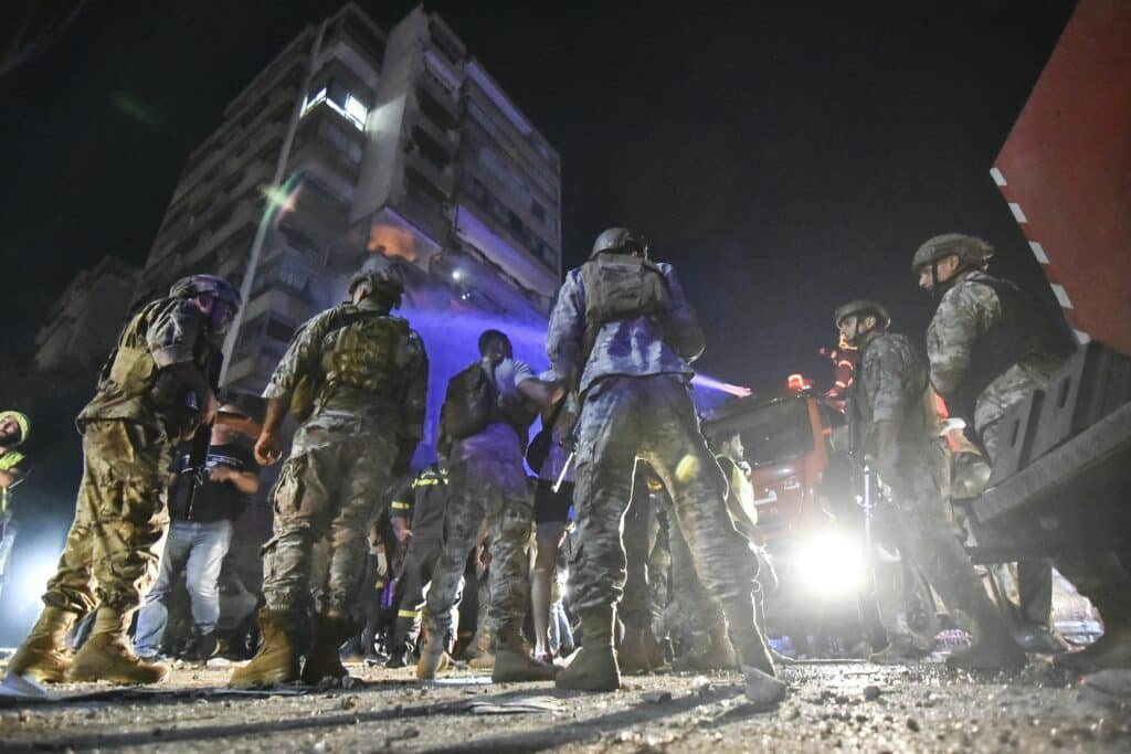 Israeli forces start 'targeted ground raids' in south Lebanon. Lebanese army soldiers secure the site outside an apartment building hit by an Israeli air strike in Beirut's Cola district, September 30, 2024.  | Photo by Fadel ITANI / AFP