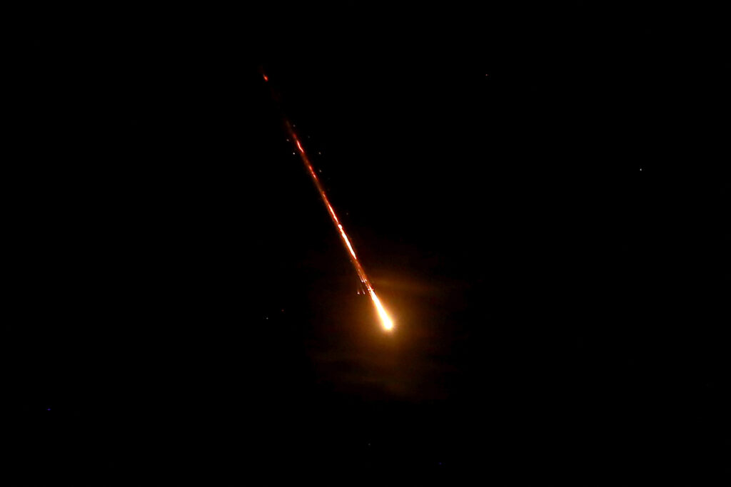 Iran fires at least 180 missiles into Israel as Mideast conflict grows. This picture shows a projectile flying above the Jordanian capital Amman towards Israel, on October 1, 2024. | Photo by Khalil MAZRAAWI / AFP