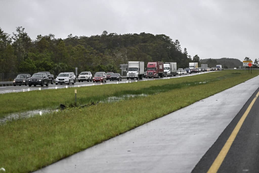 Cars drive east out of Naples, Florida, towards Miami on October 8, 2024, as Hurricane Milton approaches. | Photo by Chandan Khanna / AFP