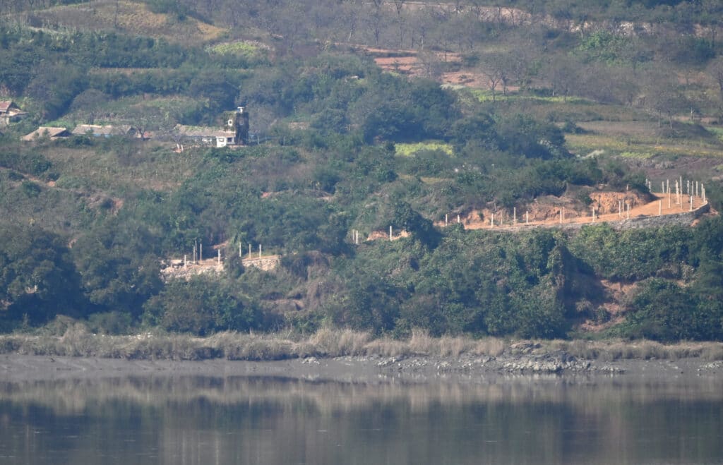 A North Korean guard post on the North side of the Demilitarised Zone (DMZ) dividing the two Koreas, is seen from South Korea's Odusan Unification Observatory in Paju on October 9, 2024. | Photo by Jung Yeon-je / AFP