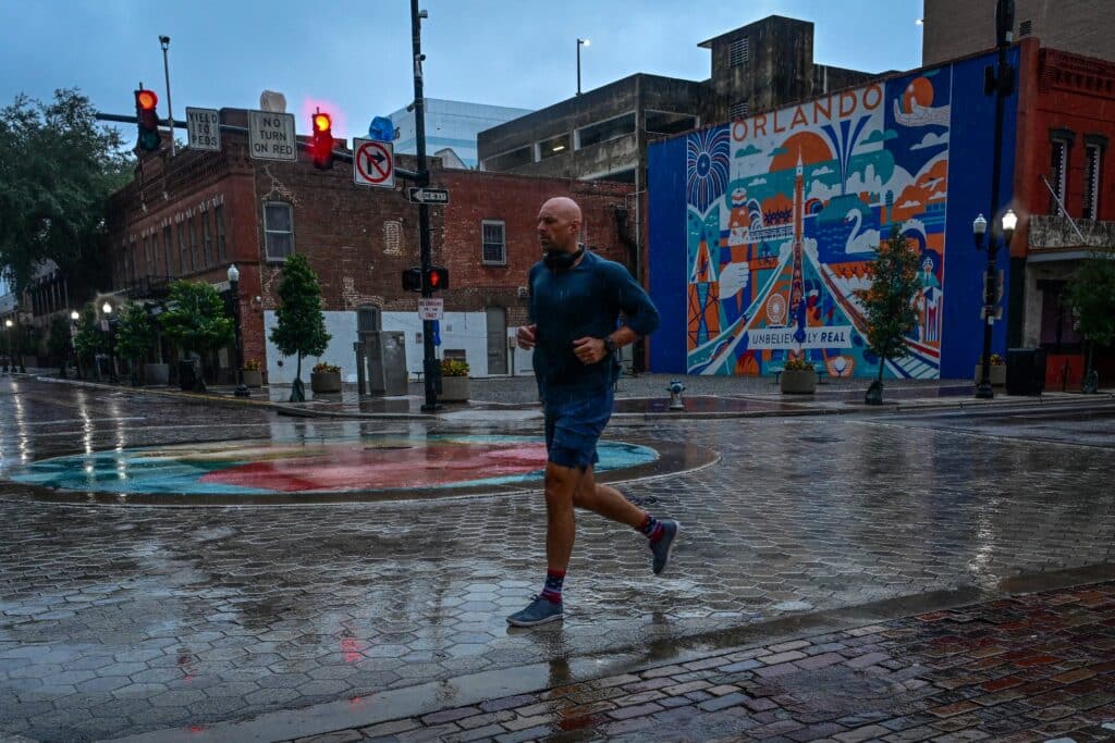 Hurricane Milton draws near, Florida seaside haven a ghost town. A man jogs in downtown Orlando, Florida, as Hurricane Milton is expected to make landfall tonight, October 9, 2024. | Photo by GIORGIO VIERA / AFP