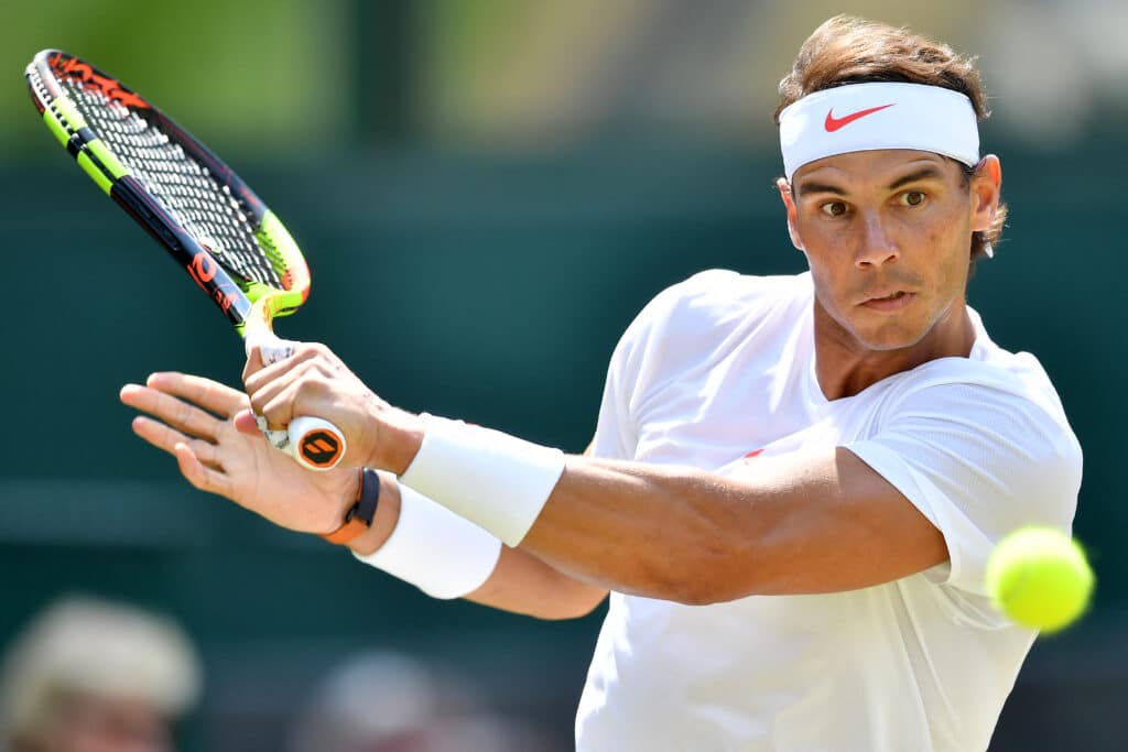 (FILES) Spain's Rafael Nadal returns against Australia's Alex De Minaur during their men's singles third round match on the sixth day of the 2018 Wimbledon Championships at The All England Lawn Tennis Club in Wimbledon, southwest London, on July 7, 2018. | Photo by Ben STANSALL / AFP