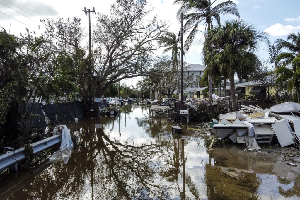 Milton’s ‘reverse surge’: Why it sucked water away from Tampa Bay. In photo is a flooded street with debris in the aftermath of Hurricane Milton, in Siesta Key, Florida, on October 10, 2024. | Photo by CHANDAN KHANNA / AFP