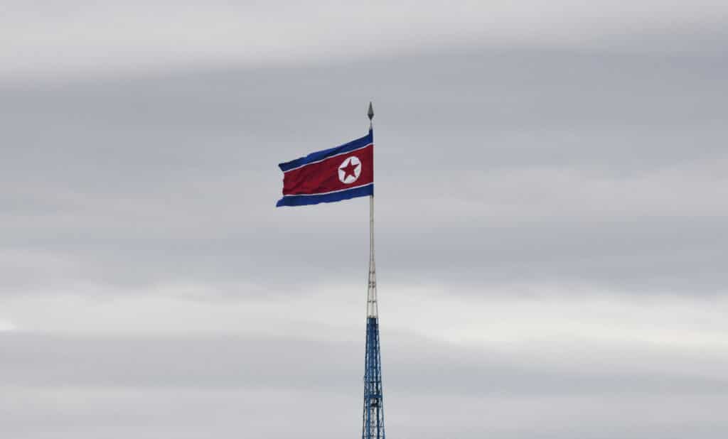 North Korea blows up roads, rails to South. (FILES) A North Korean flag flutters in the propaganda village of Gijungdong as seen from South Korea's Taesungdong freedom village sitting inside the Demilitarized zone dividing the two Koreas in Paju on April 24, 2018.| Photo by Jung Yeon-je / AFP