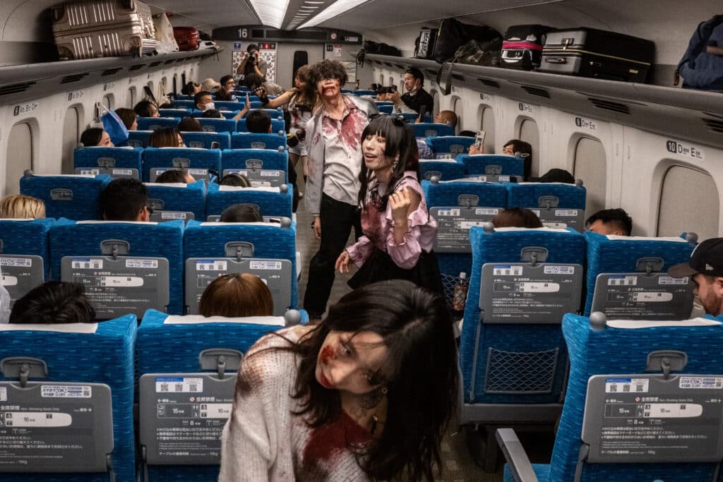 Actors perform for passengers during the 'Zombie Shinkansen' event on a bullet train from Tokyo to Osaka, ahead of Halloween on October 19, 2024. | Photo by Philip FONG / AFP