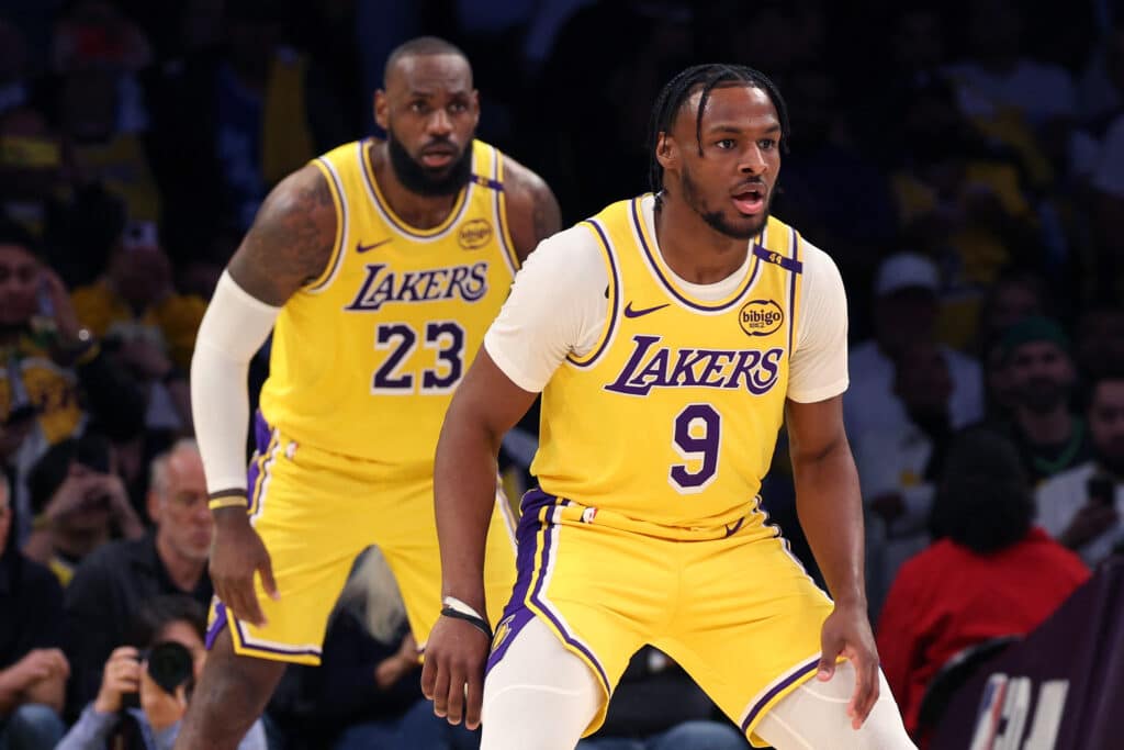 LeBron James #23 and Bronny James #9 of the Los Angeles Lakers play defense during the second quarter against the Minnesota Timberwolves at Crypto.com Arena on October 22, 2024 in Los Angeles, California. Photo by Harry How/Getty Images via AFP