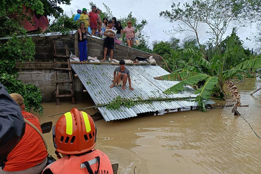 Kristine batters Luzon: 14 dead, thousands evacuated. This handout photo taken and released on October 23, 2024 by the Philippine Coast Guard (PCG) shows residents affected by Tropical Storm Trami being evacuated from the roofs of their submerged houses, in Libon town, Albay province, South of Manila. | Photo by Handout / Philippine Coast Guard (PCG) / AFP