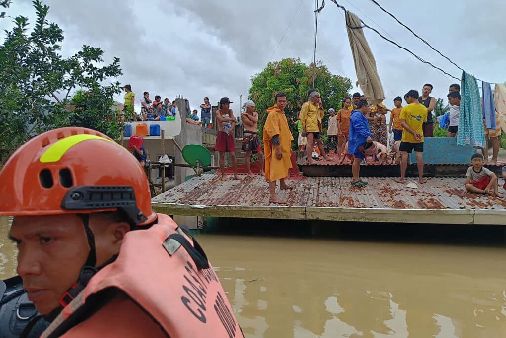 Kristine batters Luzon: 14 dead, thousands evacuated. This handout photo taken and released on October 23, 2024 by the Philippine Coast Guard (PCG) shows residents affected by Tropical Storm Trami standing on the roofs of their submerged houses before being evacuated, in Libon town, Albay province, South of Manila. | Photo by Handout / Philippine Coast Guard (PCG) / AFP