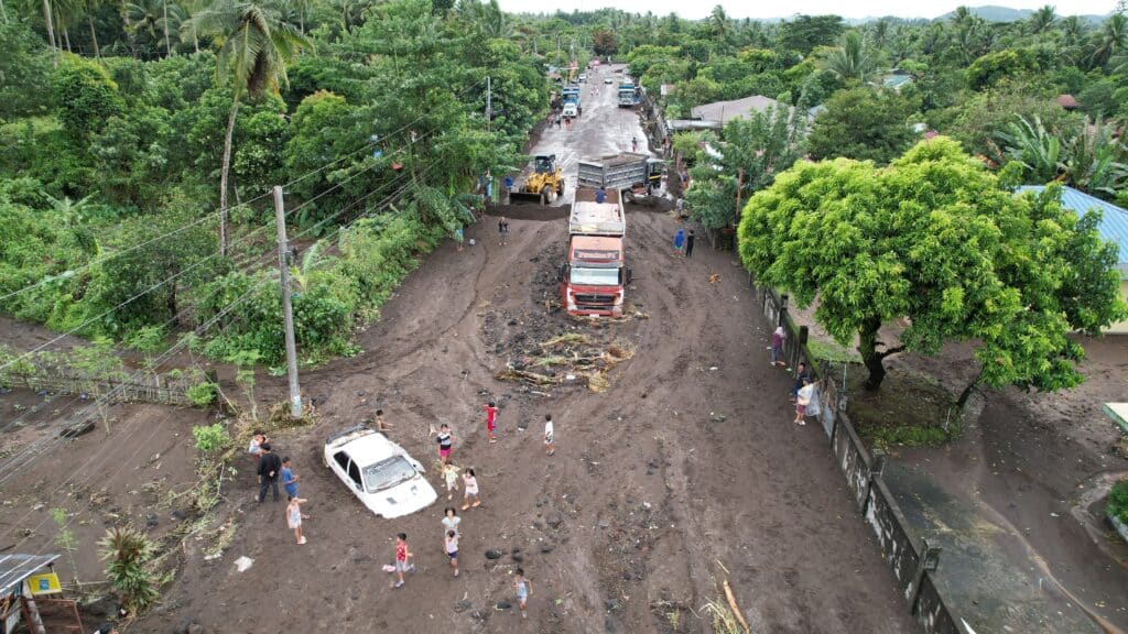 An aerial shot of vehicles buried by volcanic ash from nearby Mayon volcano which cascaded into a village triggered by heavy rains brought about by Tropical Storm Trami at a village in Guinobatan town, Albay province South of Manila on October 23, 2024. | Photo by Charism SAYAT / AFP