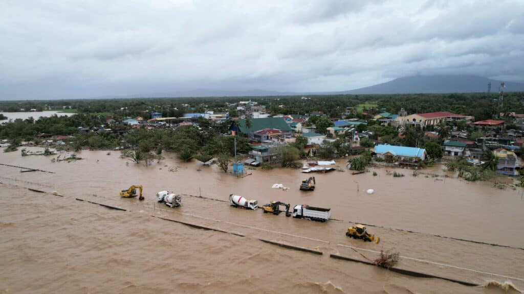 Kristine leaves towns submerged, 40 dead. An aerial view shows inundated construction vehicles (foreground C) and flooded houses (background) caused by heavy rains brought about by Tropical Storm Trami in Bato town, Camarines Sur province on October 24, 2024. | Photo by Zalrian SAYAT / AFP