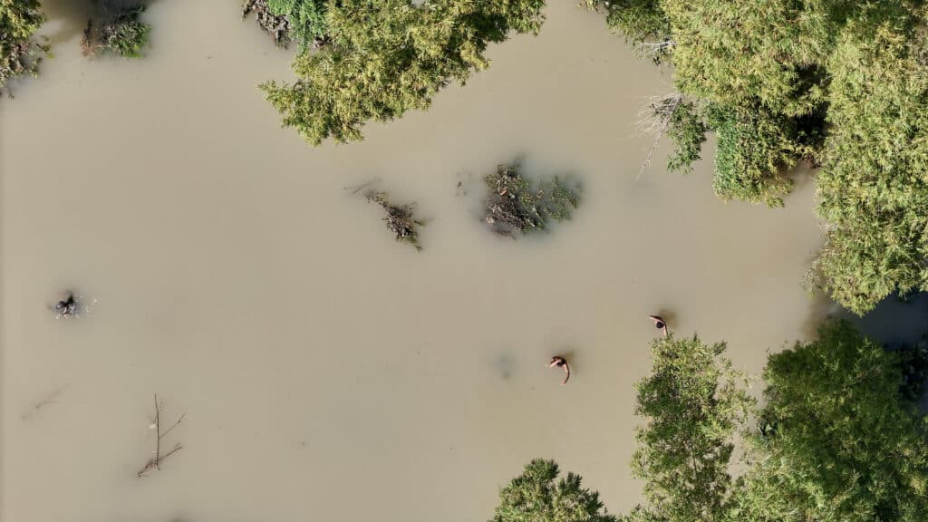 Kristine death toll rises to 110, says Office of Civil Defense. This picture shows an aerial view of people wading through a flooded area as they search for the body of a villager in Tuguegarao, Cagayan province, north of Manila on October 26, 2024. | Photo by John DIMAIN / AFP