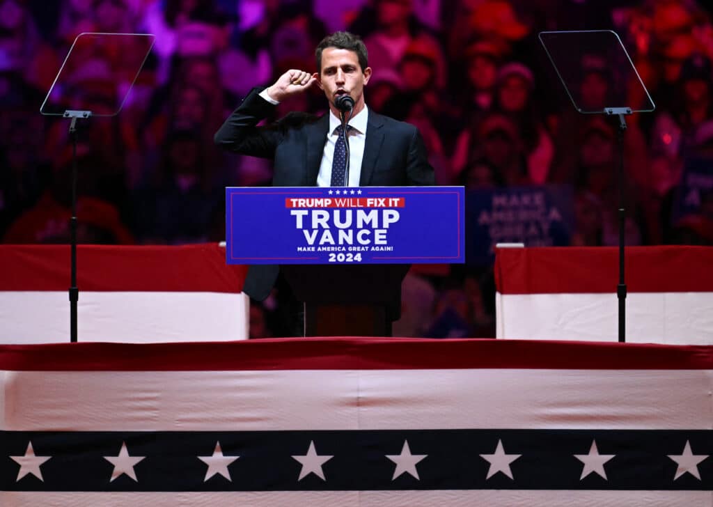 (FILES) US comedian Tony Hinchcliffe speaks during a campaign rally for former US president and Republican presidential candidate Donald Trump at Madison Square Garden in New York on October 27, 2024. | Photo by ANGELA WEISS / AFP