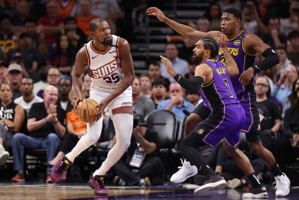 NBA: Booker scores 30, Durant 33 as Suns give Lakers its 1st loss, In photo is Kevin Durant #35 of the Phoenix Suns handling the ball under pressure from Gabe Vincent #7 and Rui Hachimura #28 of the Los Angeles Lakers during the second half of the NBA game at Footprint Center on October 28, 2024 in Phoenix, Arizona. | Photo by Christian Petersen/ Getty Images via AFP