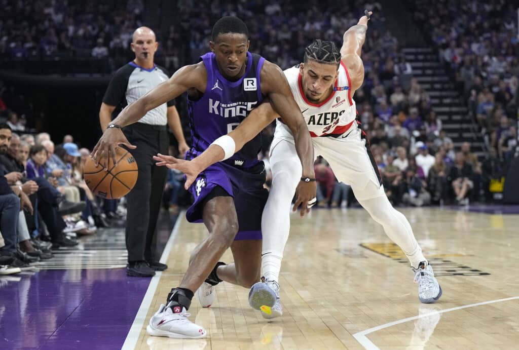 Toumani Camara #33 of the Portland Trail Blazers knocks the ball away from De'Aaron Fox #5 of the Sacramento Kings during the first quarter at Golden 1 Center on October 28, 2024 in Sacramento, California. | Photo by Thearon W. Henderson / Getty Images via AFP)