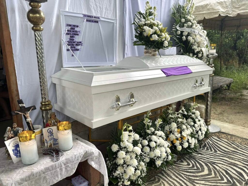 Carcar: Lightning strikes 2 students playing soccer, 1 dead, 1 hurt. In photo is the coffin with the body of the dead student in his house in Carcar City where his wake is being held.