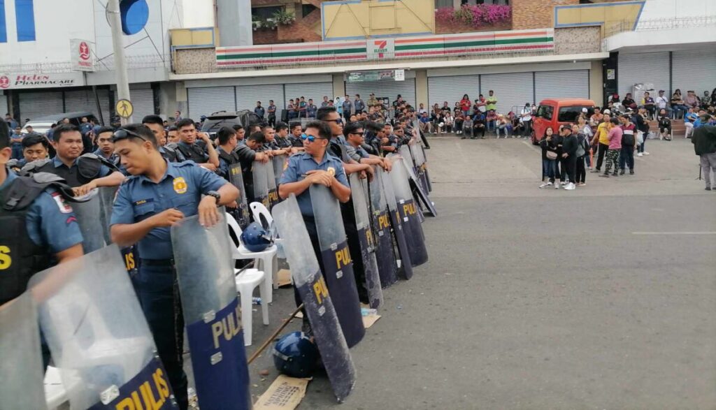 ‘KINGDOM’ SIEGE Antiriot policemen assemble outside the Kingdom of Jesus Christ compound in Davao City in this photo taken on Aug. 29, at the height of the massive manhunt for the sect’s controversial founder and televangelist Apollo Quiboloy. —JOSELLE R. BADILLA