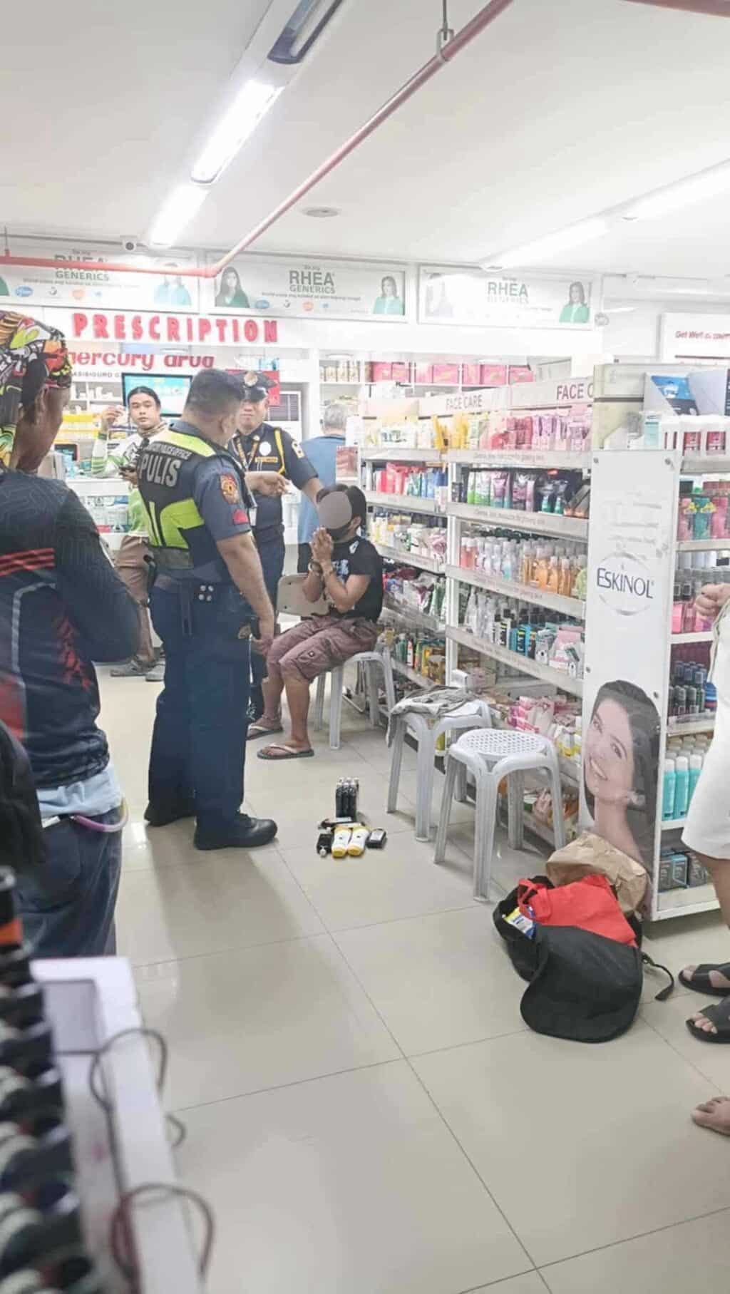 A man who was caught shoplifting bottles of liniment oil in a Cebu City pharmacy is turned over to police. | Contributed photo