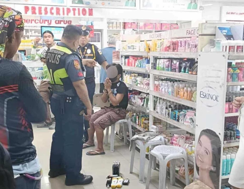 A man who was caught shoplifting bottles of liniment oil in a Cebu City pharmacy is turned over to police. | Contributed photo