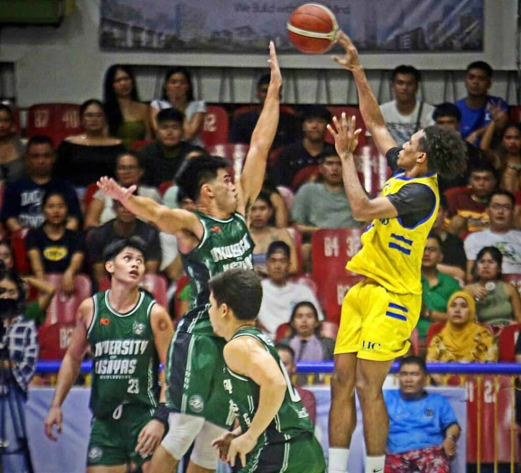 UC's Luther Leonard goes for a jumper while being defended by UV's Ivan Alsola during their Cesafi Season 24 Men's Basketball Tournament game. | Photo from Sugbuanong Kodaker