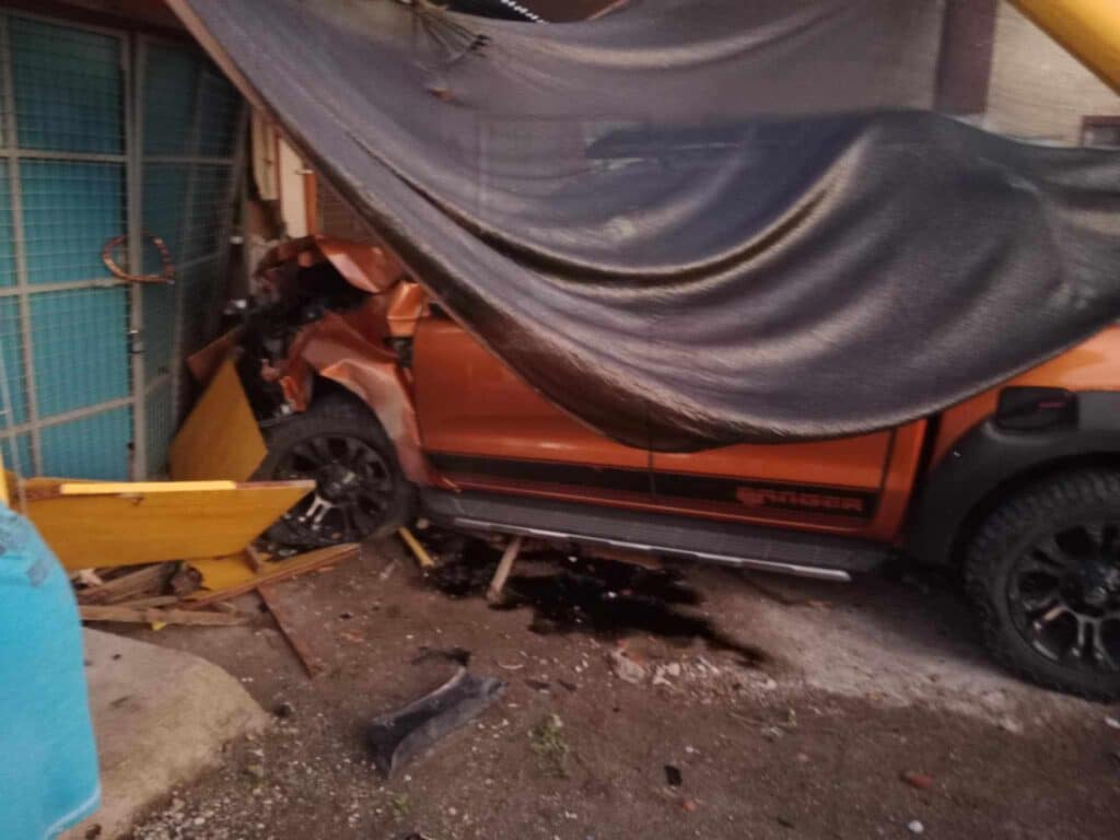 Argao, Cebu accident: American driving truck rams tricycle, 1 dead. This is the pickup truck driven by the American after it hit the motorcycle and crashing into the front wall of this house along the road. | Paul Lauro