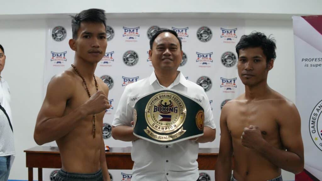 PMI Bohol Boxing Promotions chief, Floriezyl Echavez-Podot holding the PBF minimumweight title, while his boxer Shane Gentallan (left) and opponent Rholdan Sasan (right) strike a pose during the official weigh-in. | Photo from PMI Bohol Boxing Promotions